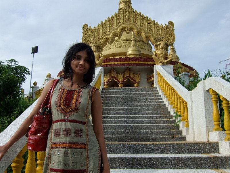 Anika on the steps of a big Buddhist temple overlooking the town
