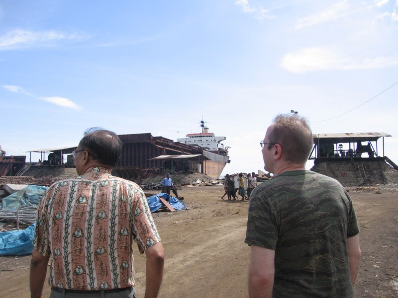 Abbu (my dad) and Chuck. the labourers in the distance are carrying a huge refrigerator.  almost all manual labour here - everything is done by hand.  no cranes to lift & move heavy objects
