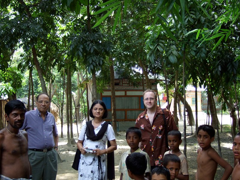 look at the hut in the background - the huts had pretty designs on them (usually huts in the villages blend in with the environment).  the man to the left was very nice & friendly and showed us around this hindu village & the temples
