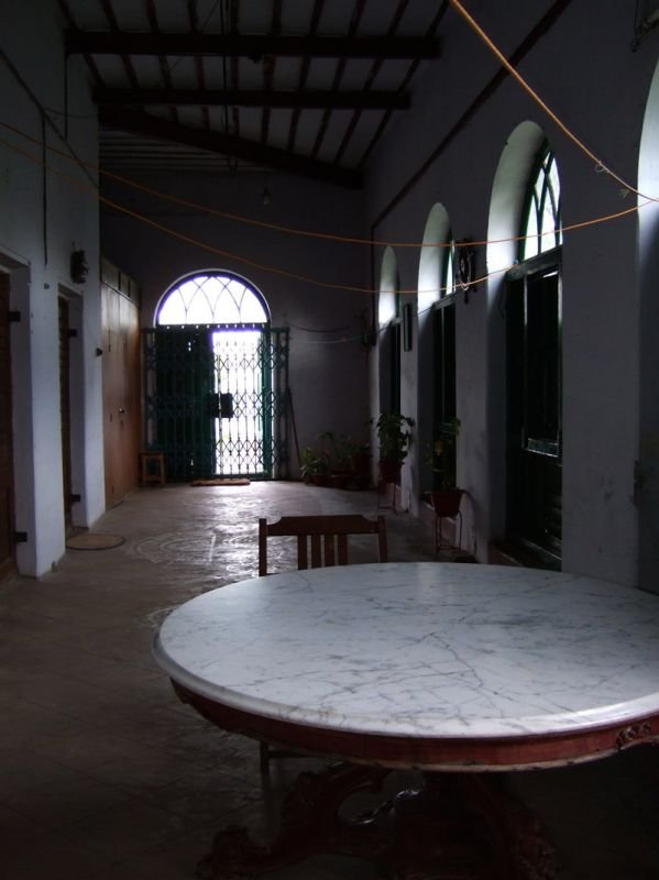 the hallway inside still has the original floor, the high ceilings, wooden shutters, and one piece of furniture left - the marble table
