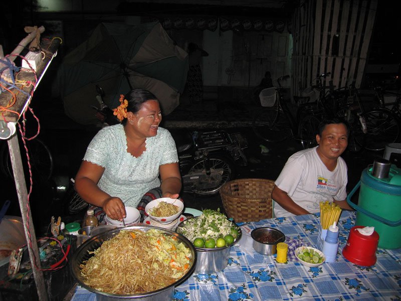 serving some kind of noodle dish and having a good time
