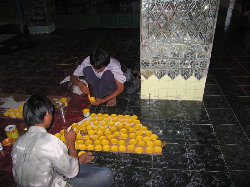 painting little clay bowls used in the pagoda
