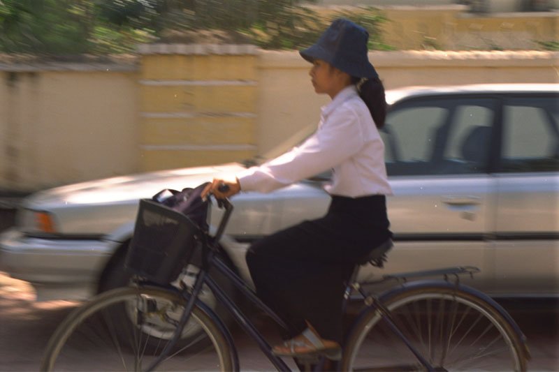 the girls riding the bicyles had such good posture
