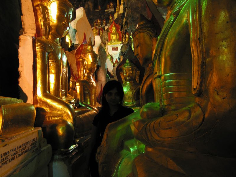 walking in the labyrinthine walkways between the buddhas in one of the many chambers of the cave
