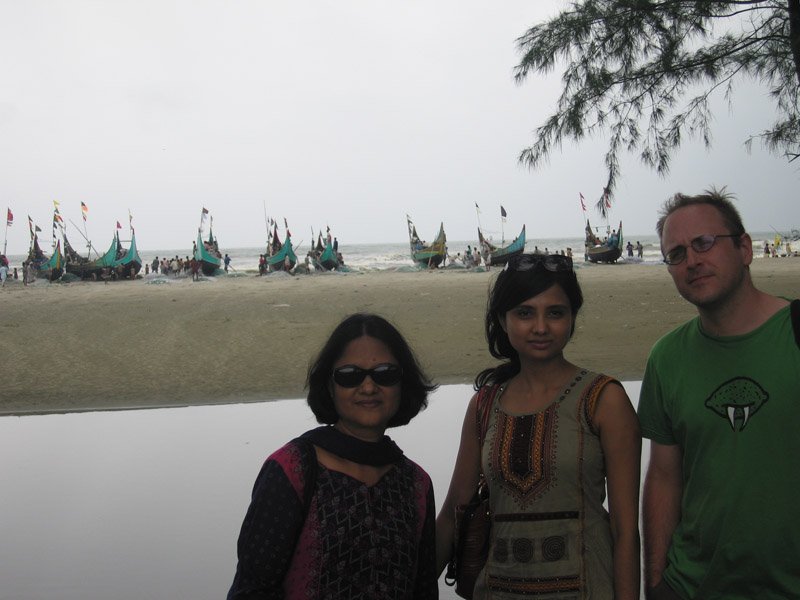 you can see the turquoise blue & yellow sampans (fishing boats) lined up on the beach
