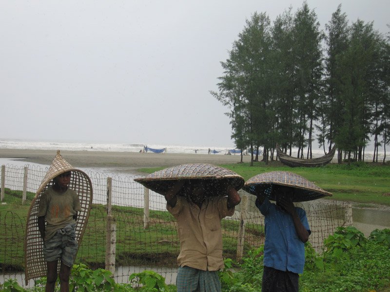 kids wearing the conical farmer hats in the rain. Chuck bought one & is wearing it in the Bandarban photos. the farmer hat styles vary across the regions of bangladesh. we're thinking of doing a coffee table book on it ;)
