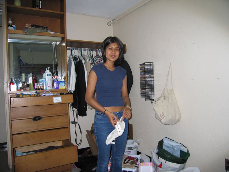 Zaynah in her room, packing
