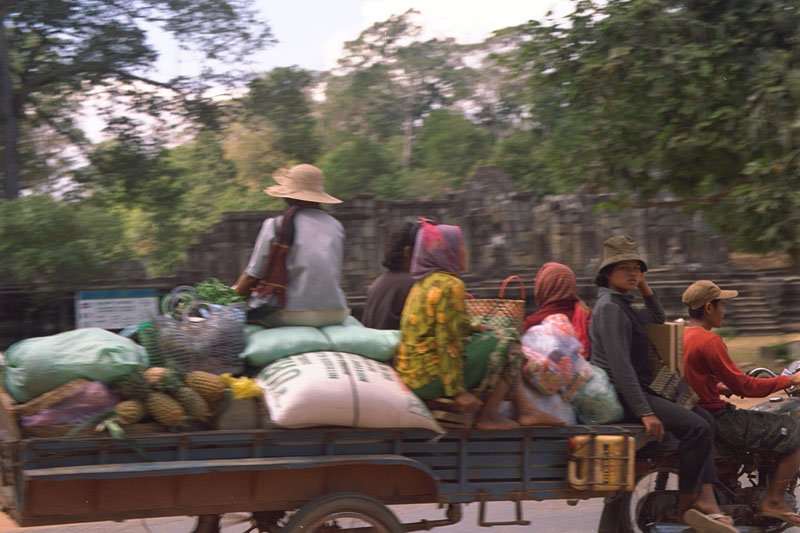 villagers carting their shopping back from market
