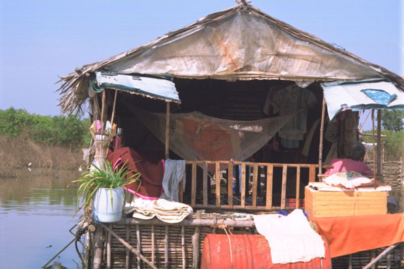 hanging out in the porch in one of the floating houses.  the hammock seems to serve as a storing area for clothes
