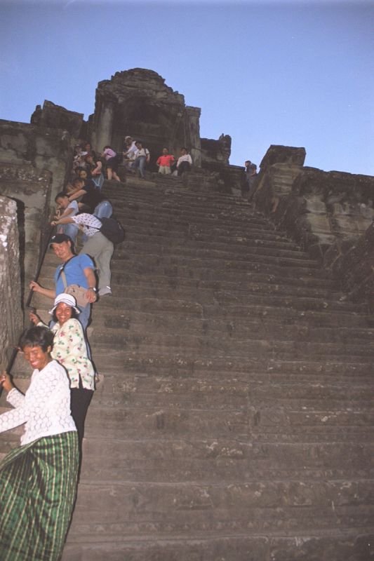 climbing down from the tower in the center of Angkor Wat.  there are stairs on each side of the tower, but this is the only side that has a railing to hold on to.  each step is really high and super narrow (you can only fit your foot sideways on a step)
