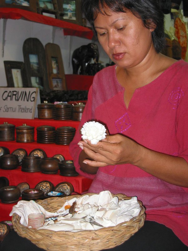 carving a block of soap into a flower.  the flower shaped soaps are really amazingly delicate - and they make them so fast!
